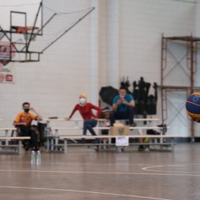 Dynamic wheelchair basketball game showcasing skill and determination indoors.